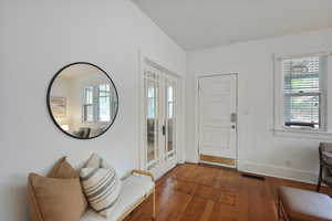 Entrance foyer featuring hardwood / wood-style flooring and baseboards