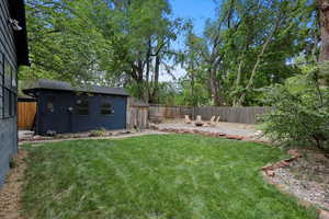 View of yard with a fire pit and an outbuilding