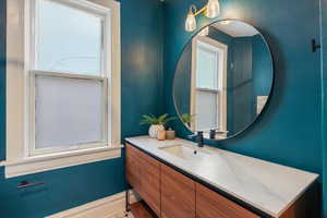 Bathroom with vanity and baseboards