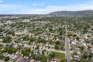 Aerial view of property's location with a mountain backdrop and nearby suburban area