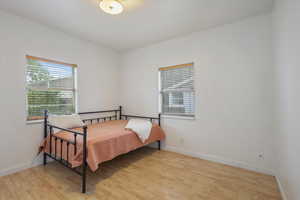 Bedroom with light wood-type flooring and baseboards