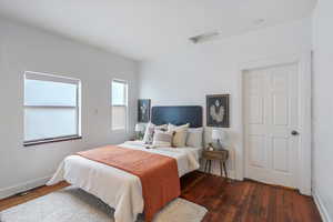 Bedroom featuring dark wood finished floors and baseboards