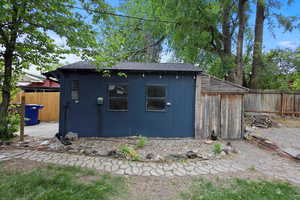 View of outdoor structure with a fenced backyard and an outbuilding