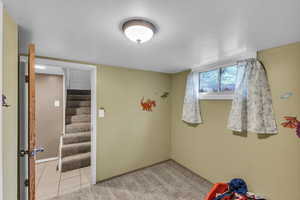 Playroom with baseboards and light tile patterned floors