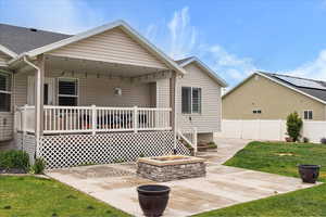 Back of property featuring a patio and a shingled roof