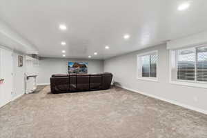Living area featuring recessed lighting, carpet flooring, and baseboards