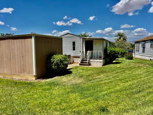 Rear view of house featuring a lawn