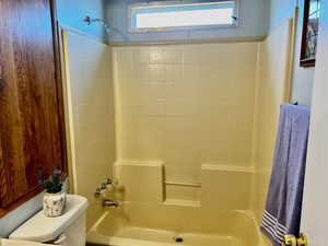 Bathroom with toilet and shower / bathtub combination