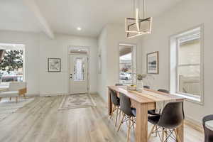 Dining space with healthy amount of natural light, light wood-style flooring, baseboards, and recessed lighting