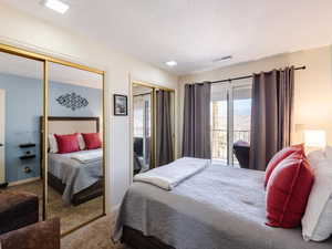 Bedroom with carpet, multiple closets, and baseboards