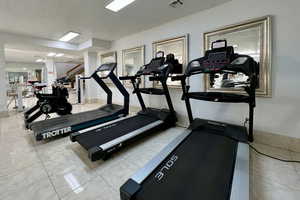 Exercise room featuring tile patterned floors