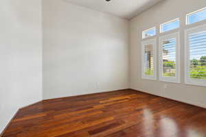 Unfurnished room with hardwood / wood-style flooring and baseboards