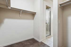 Spacious closet featuring carpet flooring