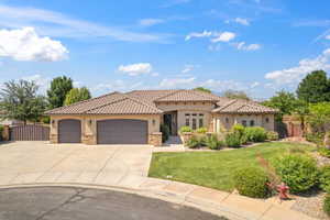 Mediterranean / spanish-style house with stucco siding, stone siding, a garage, concrete driveway, and a tile roof