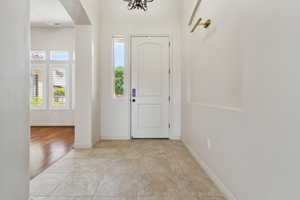 Foyer entrance featuring arched walkways and baseboards