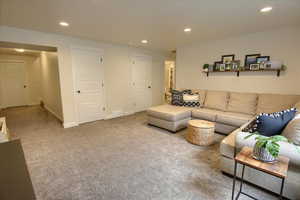 Living room featuring recessed lighting, carpet flooring, and baseboards