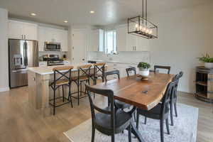 Dining room featuring light wood-style floors, recessed lighting, and baseboards
