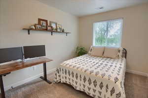 Carpeted bedroom with baseboards