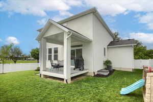 Back of house featuring stucco siding and a playground