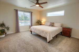 Bedroom featuring baseboards, carpet, and ceiling fan