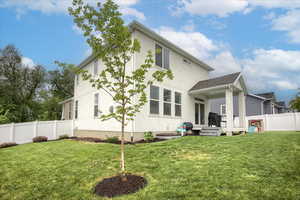 Rear view of property with stucco siding and a deck