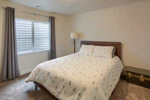 Bedroom with carpet floors and baseboards