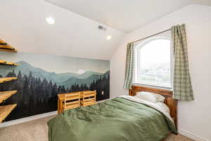 Carpeted bedroom with lofted ceiling, a mountain view, and baseboards