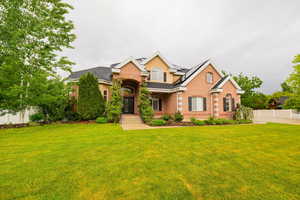 Traditional-style home featuring brick siding and roof mounted solar panels
