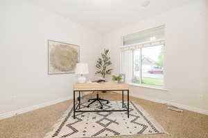Carpeted home office with baseboards
