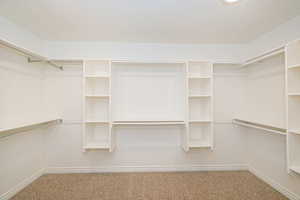 Walk in closet featuring carpet flooring