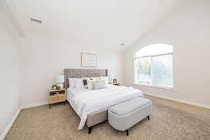 Bedroom with carpet, baseboards, and vaulted ceiling