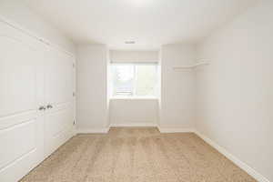 Unfurnished bedroom featuring carpet flooring and baseboards