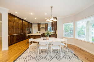 Dining room with ornamental molding, healthy amount of natural light, recessed lighting, baseboards, and light wood-style floors