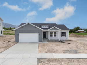 View of front of home with board and batten siding, a garage, a porch, driveway, and a mountain view