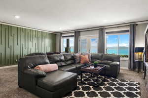 Living area featuring carpet floors, a water view, plenty of natural light, and recessed lighting