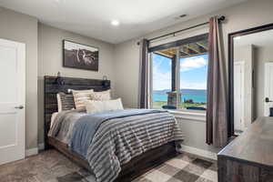Bedroom with a water view, recessed lighting, and carpet floors