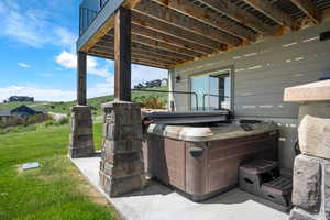 View of patio with a hot tub