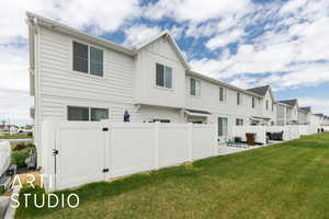 Rear view of property with board and batten siding, a patio area, and a residential view