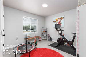 Workout room with carpet floors and baseboards