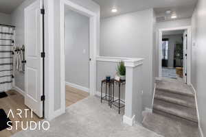 Corridor with carpet floors, baseboards, and recessed lighting