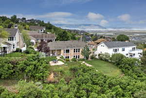 Aerial perspective of suburban area featuring a mountainous background