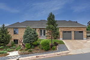 View of front of house featuring brick siding, french doors, a garage, a shingled roof, and concrete driveway
