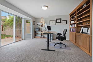 Office featuring light carpet and baseboards