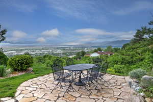 View of patio with outdoor dining area and a mountain view