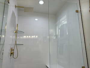 Bathroom featuring a tile shower and recessed lighting