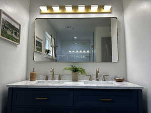 Bathroom with double vanity and a shower