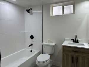 Bathroom featuring toilet, vanity, and bathing tub / shower combination