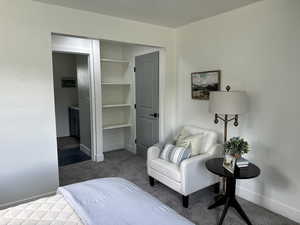 Bedroom featuring carpet and baseboards