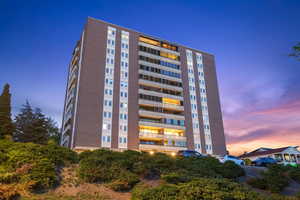 View of property at dusk