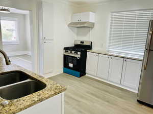 New gas stove and range hood. New cabinets with formica countertop